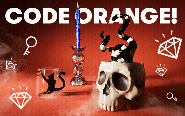 A selection of spooky Halloween decorations on a black background. 
